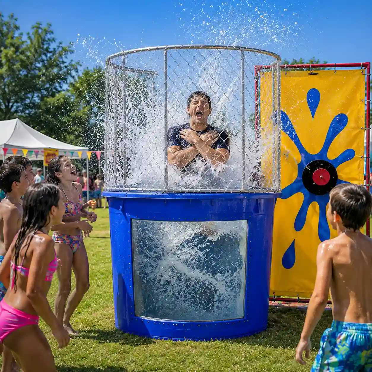 Man splashing into the water of a blue dunk tank