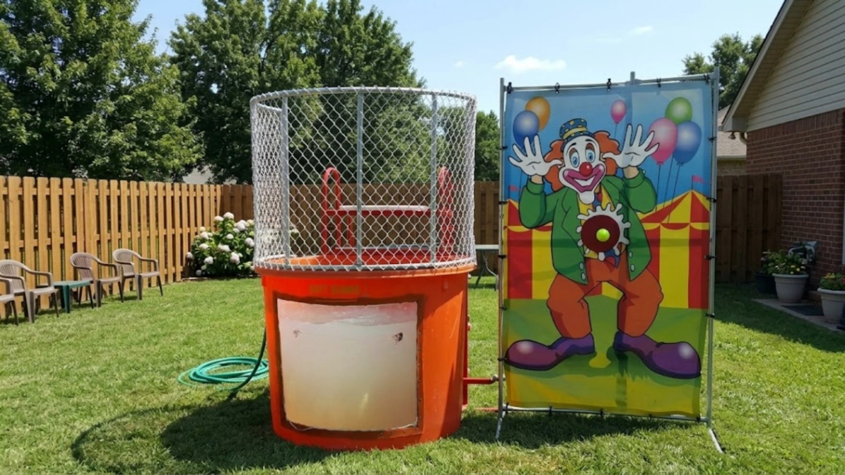 Orange dunk tank with clown target panel set up on a backyard lawn in Chicago
